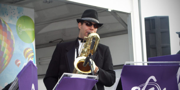 image of Jarrod Goldsmith playing sax on stage 
