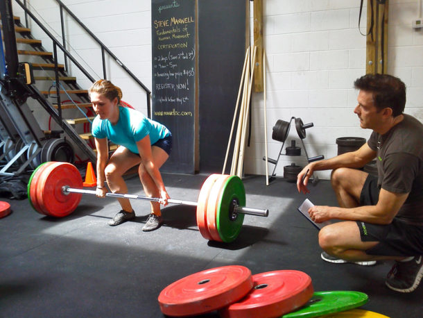 image of a woman lifting weights at StrengthBox 