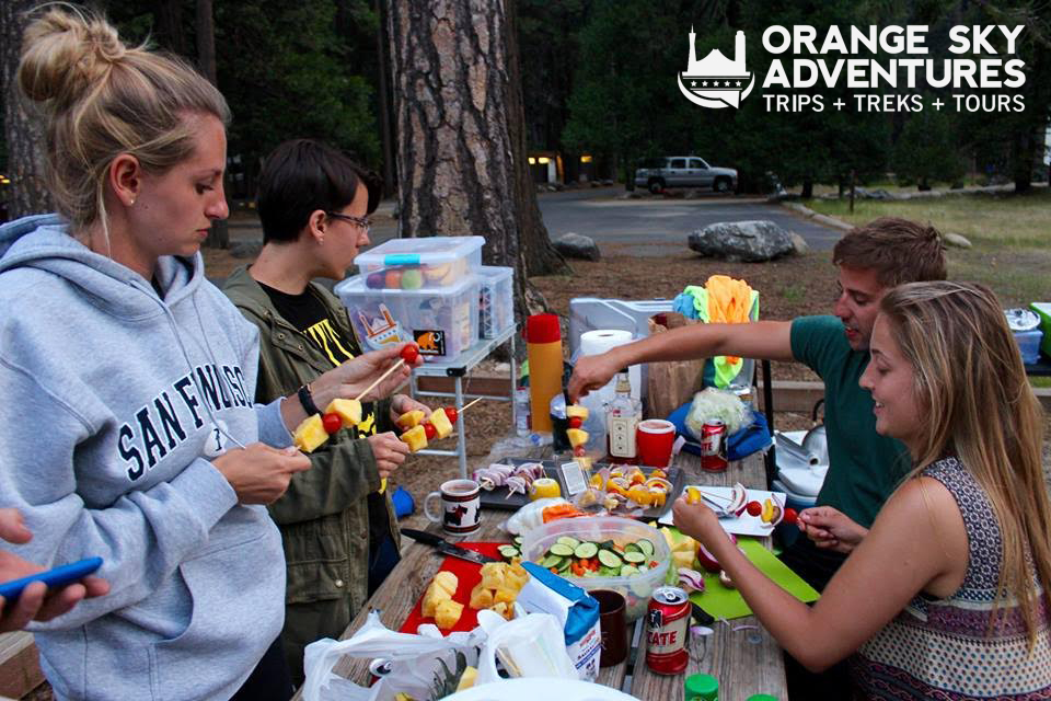 image of a crew from orange sky adventures eating