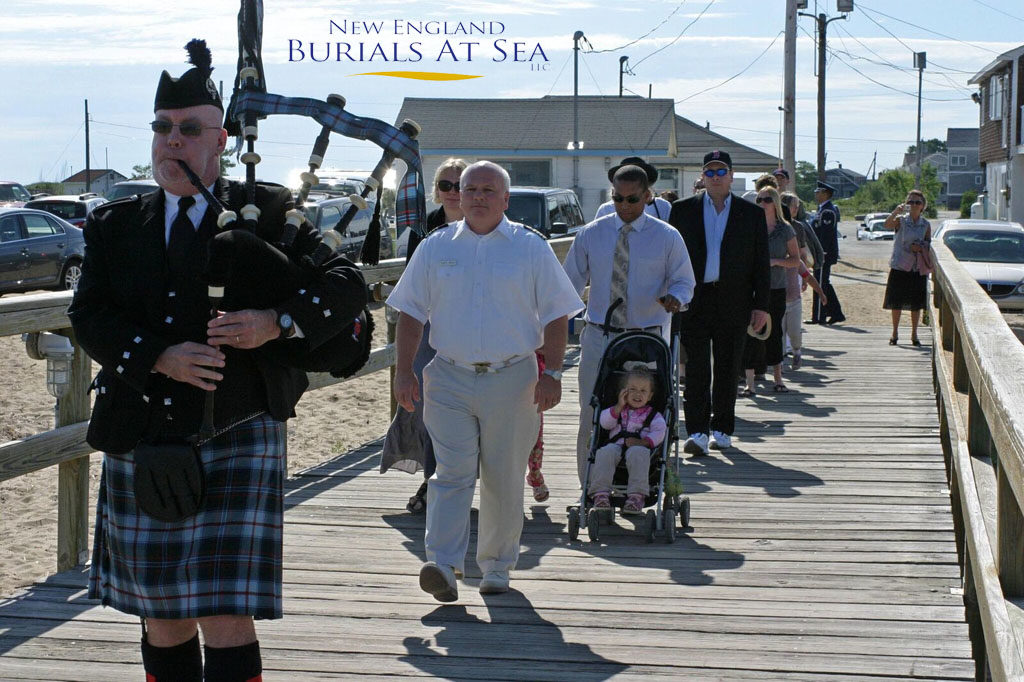 image of a piper leading a group to the sea burial